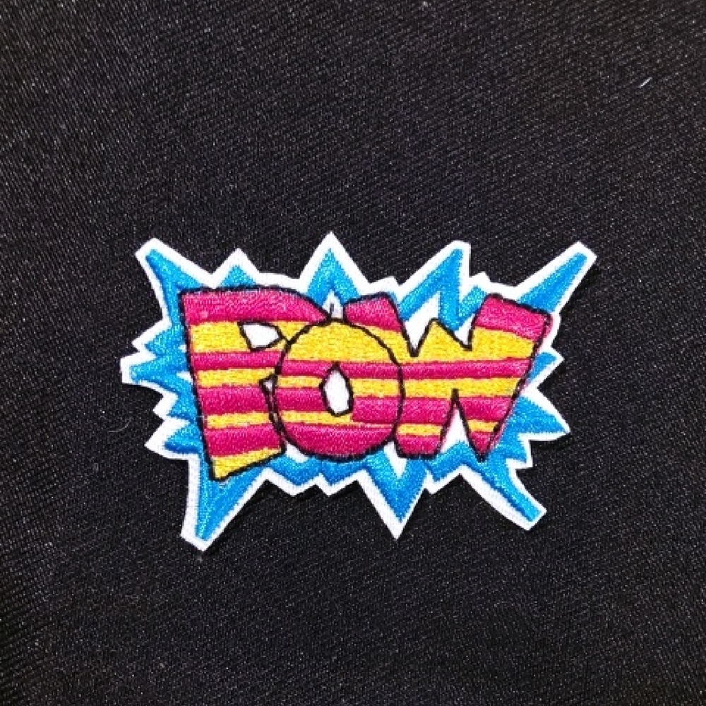 Colorful 'POW' Patch on Black Fabric Iron On